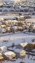 Vertical frame Aerial view of homes in snowy Utah Valley neighborhood at sunset in winter Royalty Free Stock Photo