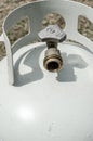 Vertical frame of an angled overhead close-up of the top of a white propane tank