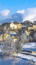 Vertical frame Beautiful houses on a snowy mountainside residential community in winter Royalty Free Stock Photo