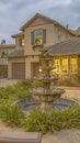 Vertical frame Beautiful tiered fountain at the garden of a home against sky with gray clouds Royalty Free Stock Photo