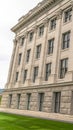 Vertical frame Building facade with decorative mouldings on the white stone exterior wall Royalty Free Stock Photo