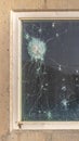 Vertical frame Bullet holes in the window glass of a bulletproof bunker Royalty Free Stock Photo