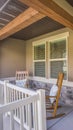 Vertical frame Facade of a home with rocking chairs on the porch and wreath on the front door Royalty Free Stock Photo