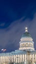 Vertical frame Facade of majestic Utah State Capital Building glowing against sky and clouds Royalty Free Stock Photo