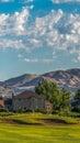 Vertical frame Fairway and bunker of golf course in front of homes with lake and mountain view Royalty Free Stock Photo