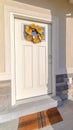 Vertical frame Front door of modern home with sunflower wreath Royalty Free Stock Photo