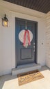 Vertical frame Front door of suburban home with welcome mat Royalty Free Stock Photo