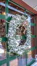 Vertical frame Frosted wreath on the glass wall of building that reflects the winter landscape