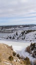 Vertical frame Frozen lake and hills blanketed with snow under cloudy blue sky in winter Royalty Free Stock Photo