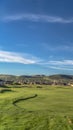 Vertical frame Golf course and houses with view of mountain towering in the distance Royalty Free Stock Photo