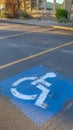 Vertical frame Handicapped parking space at a parking lot outside a building on a sunny day Royalty Free Stock Photo