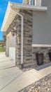 Vertical frame Home with gray and brick wall and landscaped yard leading to the entrance Royalty Free Stock Photo