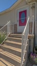 Vertical frame Home with stairs going uo to the red front door against brick and concrete wall Royalty Free Stock Photo