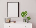 Vertical frame mockup in modern interior background. Empty frame above white chest of drawers with beautiful decor. Scandinavian Royalty Free Stock Photo