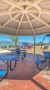 Vertical frame Octagon pavilion with blue picnic tables and view of lake and Mount Timpanogos