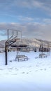 Vertical Vertical frame Panoramic view of a park and mountain covered with snow on a cloudy winter day Royalty Free Stock Photo