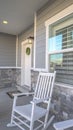 Vertical frame Porch with rocking chairs and door with wreath viewed at the facade of a home Royalty Free Stock Photo