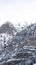 Vertical frame Provo Canyon with rugged steep slope with frozen water and snow in winter