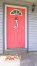 Vertical frame Red front door of house with blue porch chairs against windows with shutters Royalty Free Stock Photo