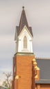 Vertical frame Side view of church exterior with focus on steeple and roof against cloudy sky Royalty Free Stock Photo