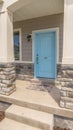 Vertical frame Stape and arched entrance at the porch of home with pastel blue front door Royalty Free Stock Photo