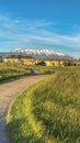 Vertical frame Sunny day view of pathway amid grassy ground leading to homes and golf course Royalty Free Stock Photo