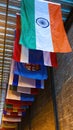 Vertical frame Vibrant colorful decorative flags against corrugated metal roof of building