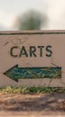 Vertical frame Views at a golf course with close up on a white Carts sign with green arrow Royalty Free Stock Photo