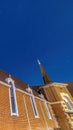 Vertical frame Vivid blue sky over a church in Provo Utah with brick wall and arched windows