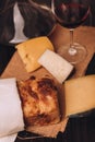 Vertical of freshly baked Italian bread with cheese and a glass of wine put on the table Royalty Free Stock Photo