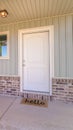 Vertical Front door and porch of home with welcome mat Royalty Free Stock Photo