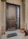 Vertical Front door with sidelight of house with bench and potted flowers at the portico Royalty Free Stock Photo