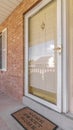 Vertical Front door of suburban brick home with welcome mat Royalty Free Stock Photo