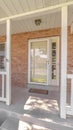 Vertical Front porch and door of traditional brick home Royalty Free Stock Photo