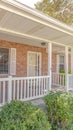 Vertical Front porch and garden of traditional brick home Royalty Free Stock Photo