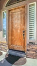 Vertical Front porch of house with wooden door and garden