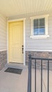 Vertical Front porch of suburban home with a yellow door Royalty Free Stock Photo
