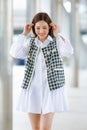 Vertical front view body portrait of cute smiling young adult Asian woman with long brown hair, wearing stylish trendy clothes, Royalty Free Stock Photo