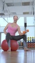 Vertical, full growth. funny bald man doing fitness in the gym