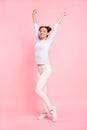 Vertical full length body size view portrait of nice winsome attractive slim fit thin cheerful dreamy girl stretching