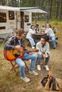 Friends Playing Guitar at Campsite Royalty Free Stock Photo