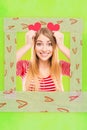 Vertical funny photo collage of pretty girl holding two paper hearts like ears close up photo frame on green background