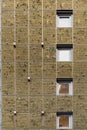 Vertical garden on a contemporary building exterior features small squared windows and a rectangles pattern filled with grass