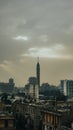 Vertical gloomy landscape of the Cairo Tower peaking behind the buildings of downtown Cairo