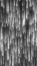 Vertical glowing light streaks resembling falling stars in monochrome style Royalty Free Stock Photo