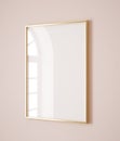 Vertical golden frame mockup close up on wall painted pastel pink color