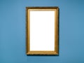 Vertical golden wood picture frame on blue wall