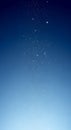 A vertical gradient of deep blue fading to a lighter blue from top to bottom, dotted with Royalty Free Stock Photo