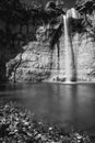 Vertical grayscale shot of the beautiful waterfall Sopot in the cave with a lake in Istria, Croatia Royalty Free Stock Photo