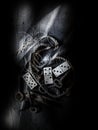 Vertical  grayscale shot of domino figures, old keys, and a rope on the floor Royalty Free Stock Photo
